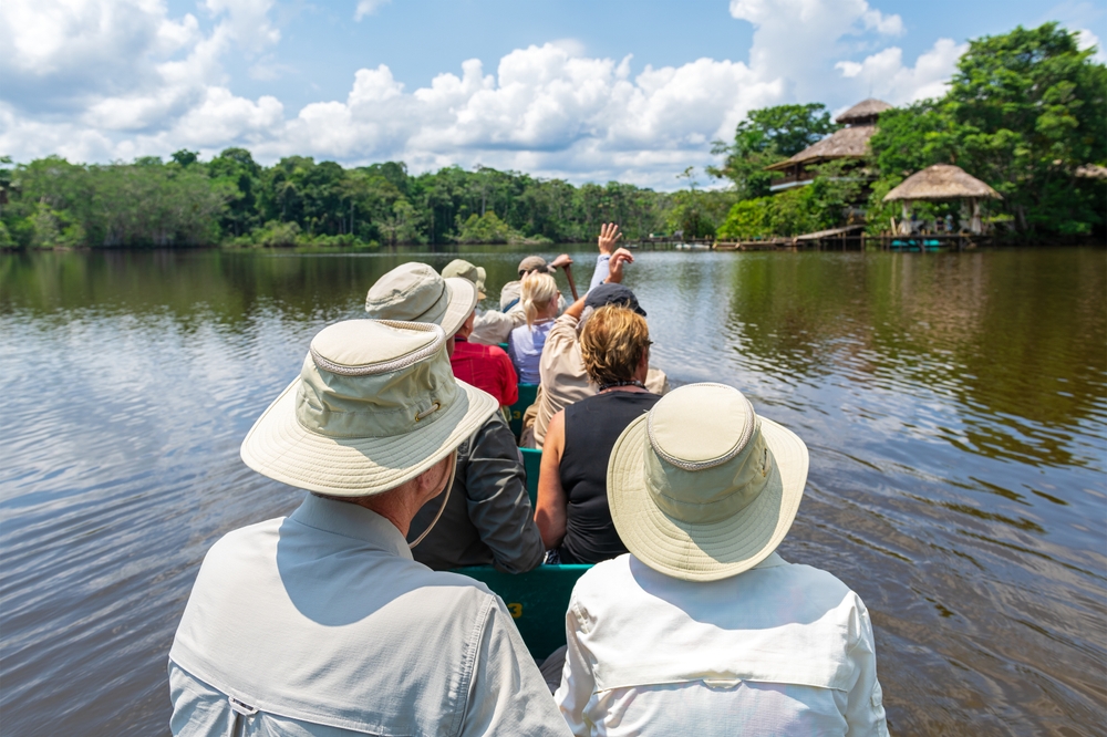 Tourist,Group,Arriving,At,Amazon,Rainforest,Lodge,By,Canoe,,Yasuni