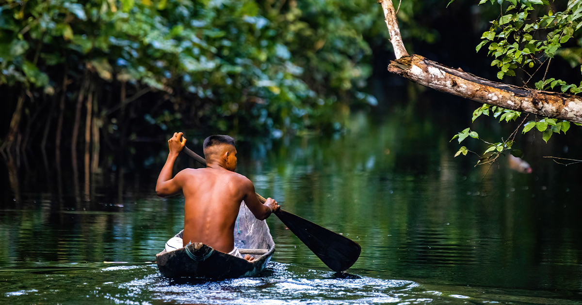 Indigenous man in canoe