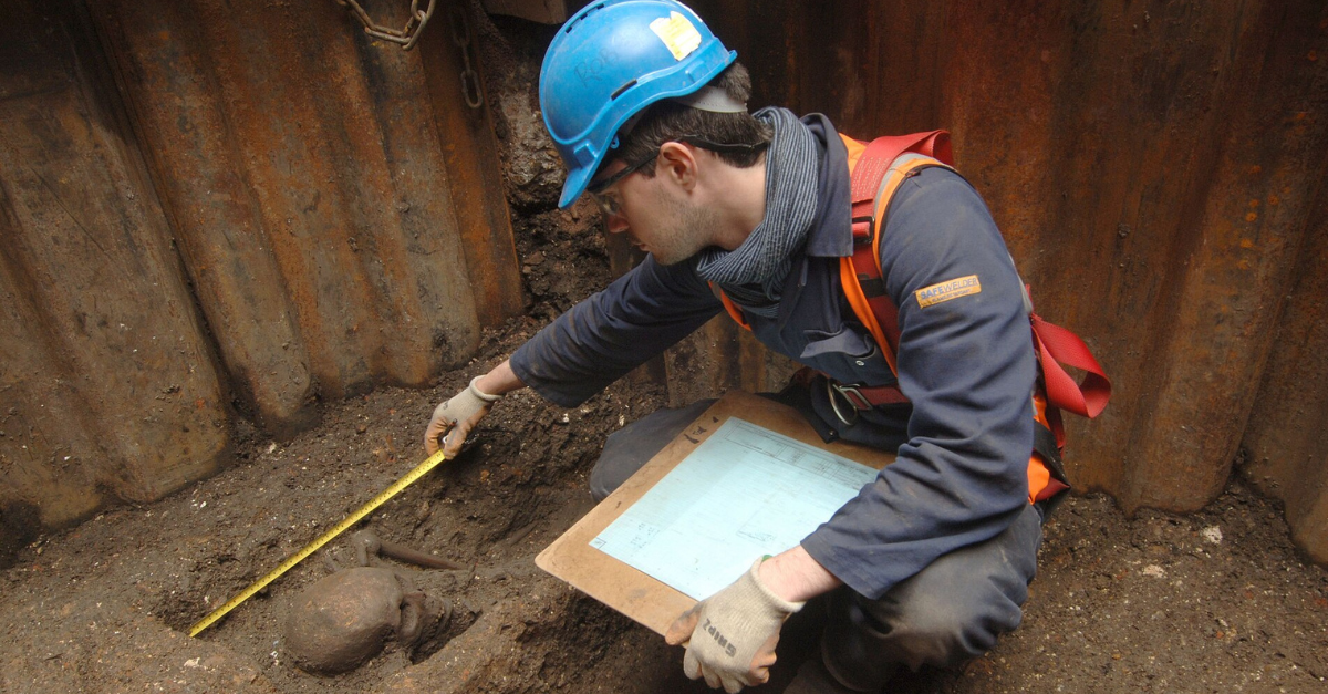 Archaeologist recording human remains
