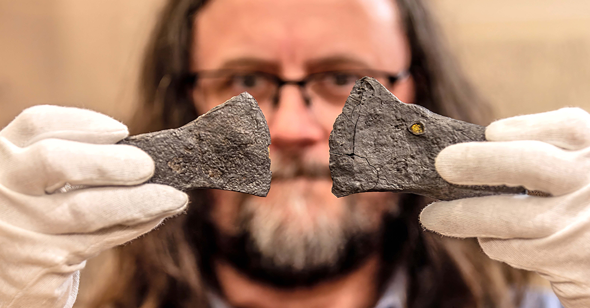05 March 2026, North Rhine-Westphalia, Olsberg: Archaeologist Manuel Zeiler shows two iron axes from the Bruchhauser Stones.