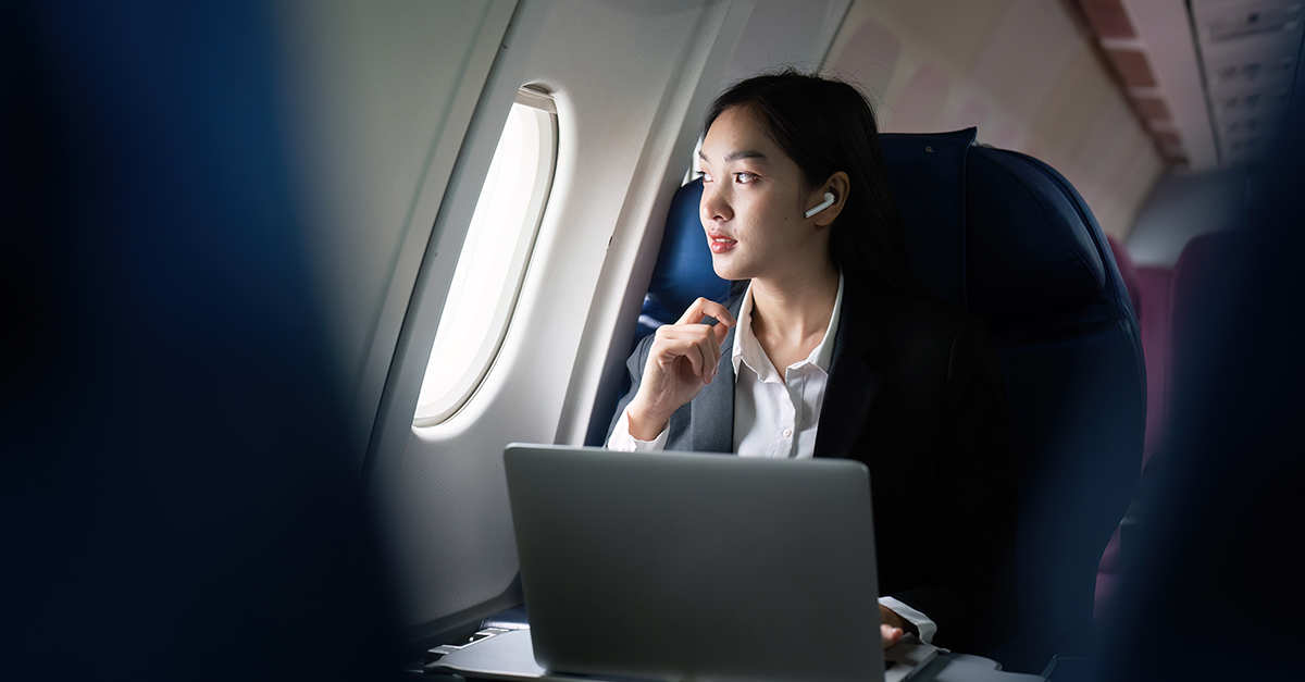 Beautiful Asian businesswoman working with laptop in aeroplane. working, travel, business concept