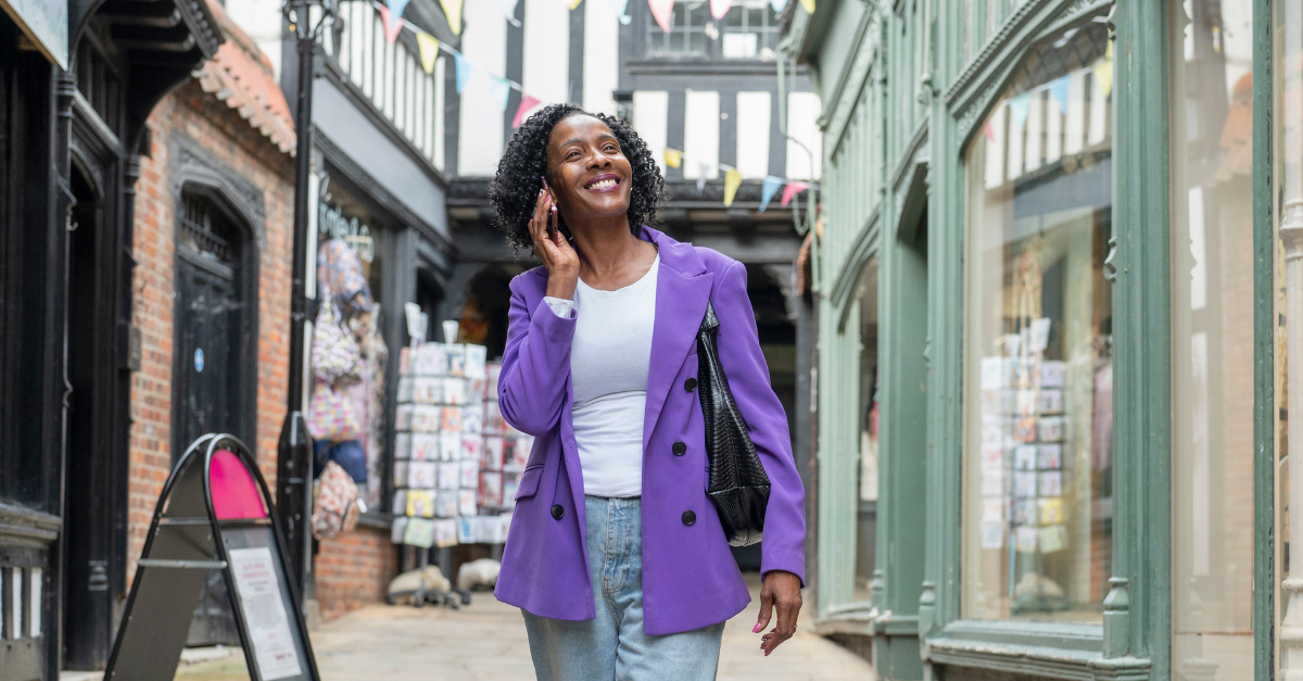 Smiling woman talking by smart phone