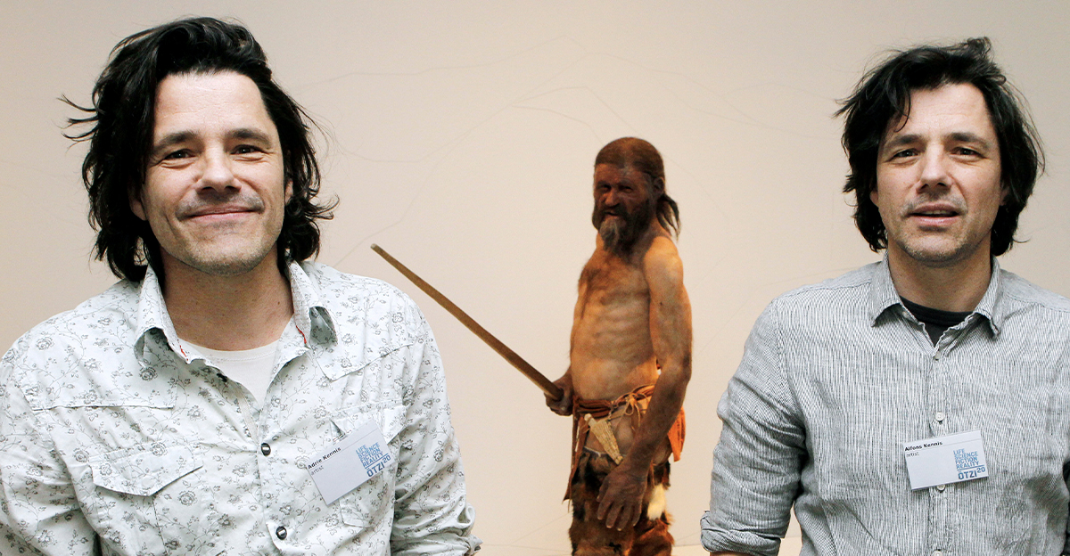 Dutch artists Adrie Kennis (L) and Alfons Kennis, who made the reconstruction of a mummy of an iceman named Otzi, discovered on 1991 in the Italian Schnal Valley glacier, pose near the statue displayed at the Archaeological Museum of Bolzano on February 2