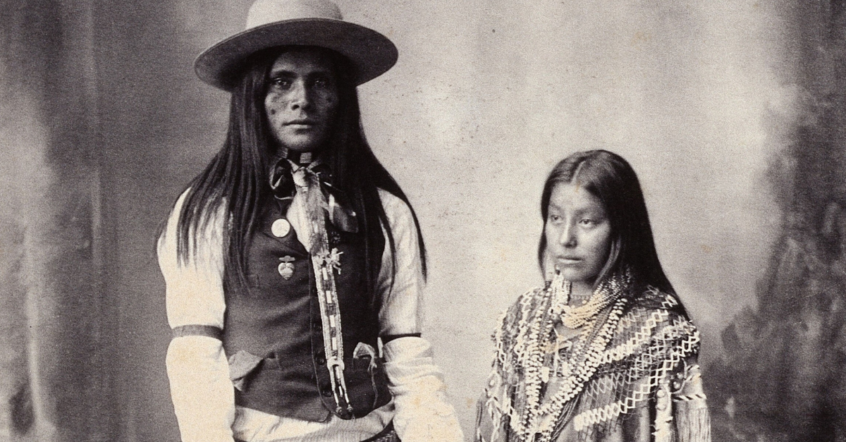 A native American man and woman Platinum print by FA Rinehart, 1898. People in vintage photograph.