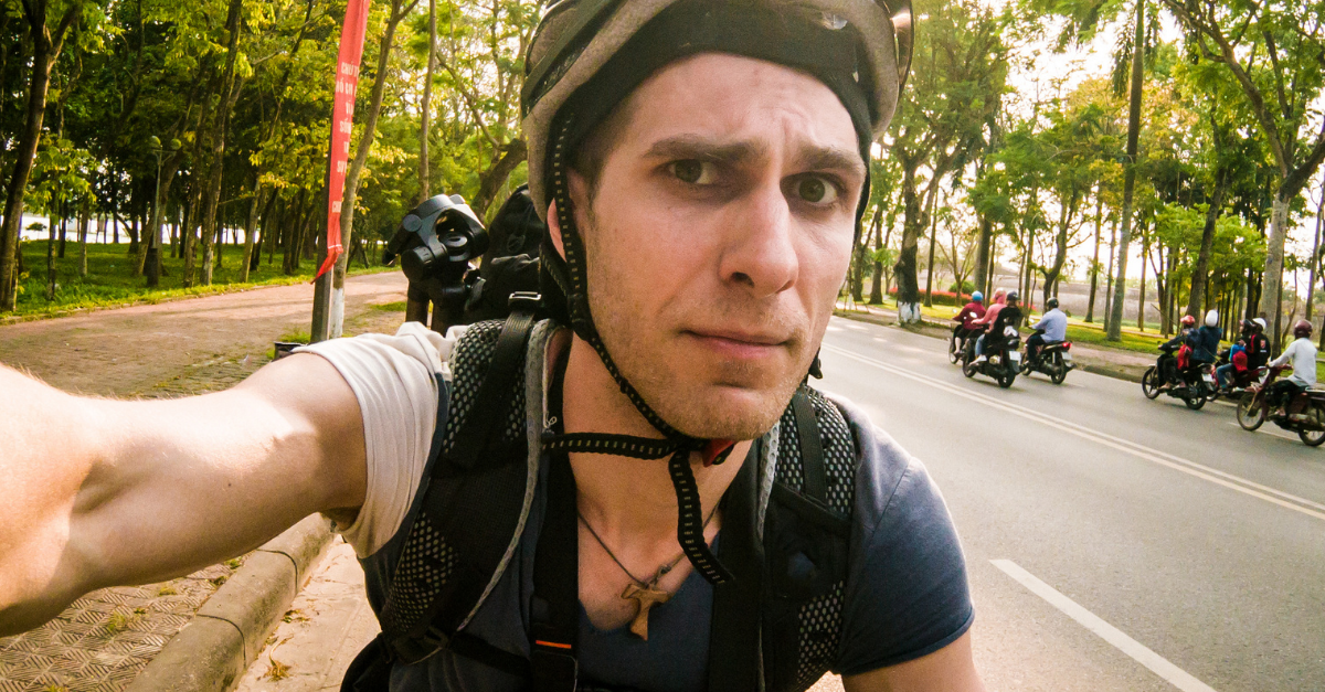 Guy cycling on a bike with concerned face