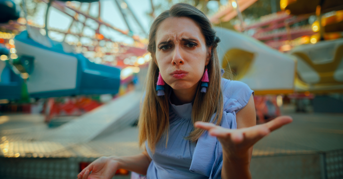 Anxious Woman Asks for Explanations in an Amusement Park Stressed lady seeks clarification at a theme park