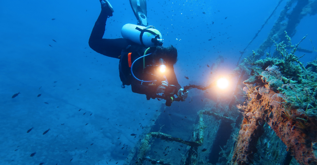 Sunken wreck and scuba diver.