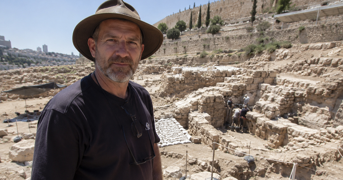 A researcher standing at an archaeology site