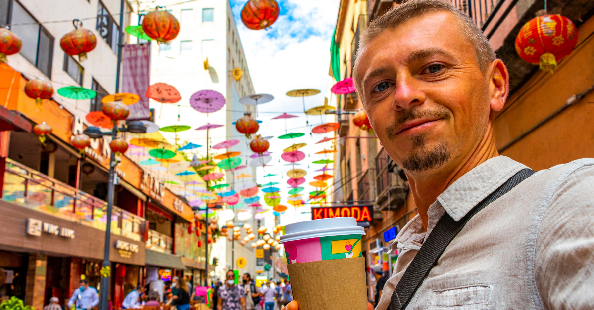 Handsome Man Tourist with Coffee in China Town Chinatown Tourist Street People Chinese Lantern Colorful Parasols and Shops in Centro Historico Mexico City Mexico.
