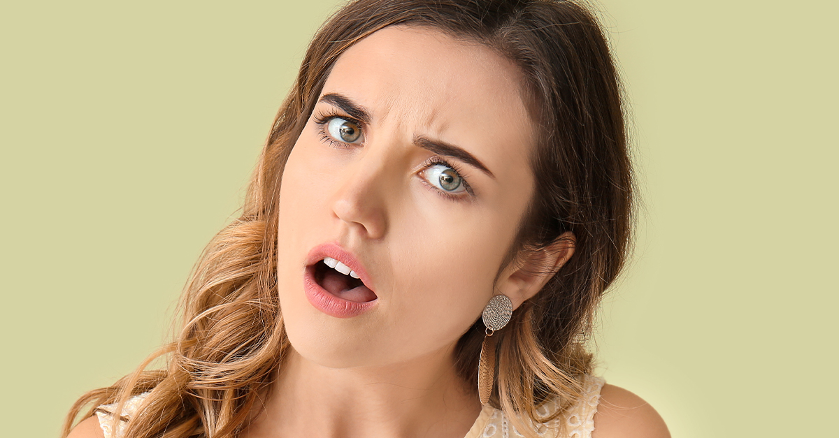 Shocked young woman, tilting her head.