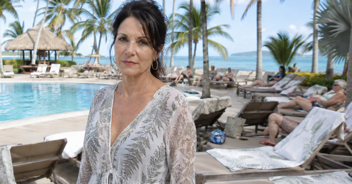 Woman standing poolside looking at camera