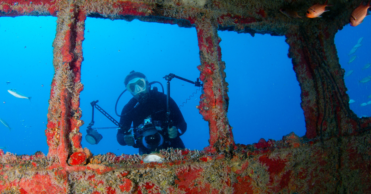 underwater-photograph-of-a-diver-with-red-wreck