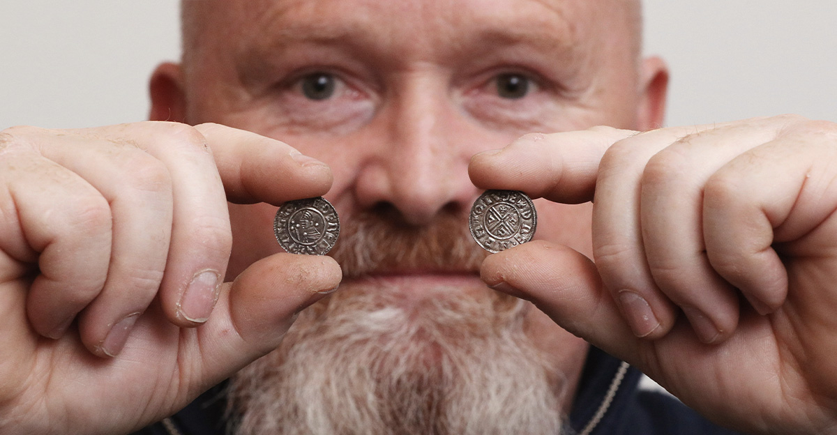 Builder and metal detectorist Don Crawley holds two particularly rare Anglo Saxon silver pennies, produced by a previously unrecorded mint in Lincolnshire, and which form part of a hoard of ninety nine Anglo Saxon silver pennies which he unearthed in Suff