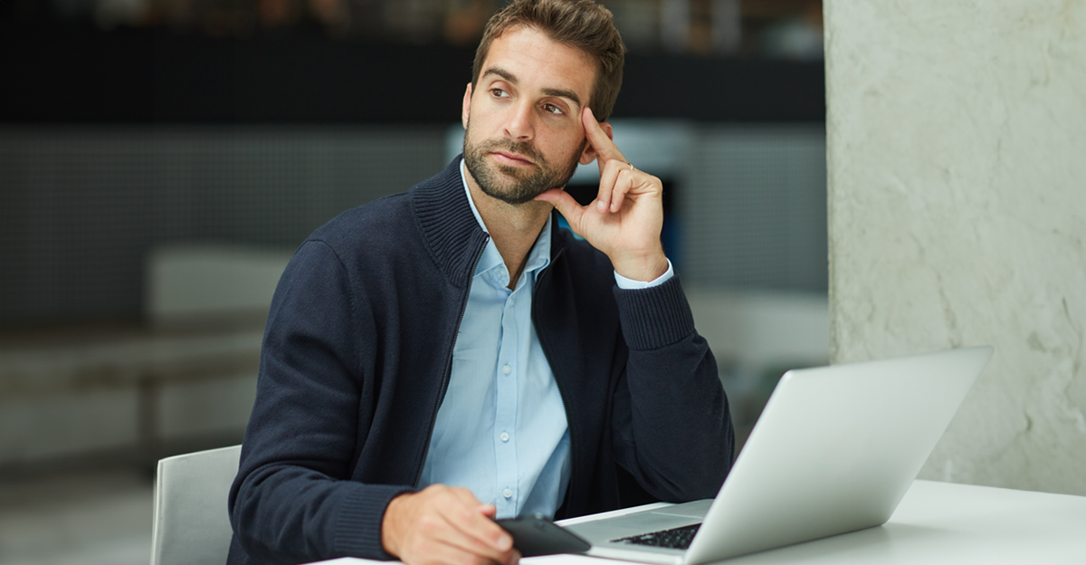 Serious, businessman and thinking with laptop