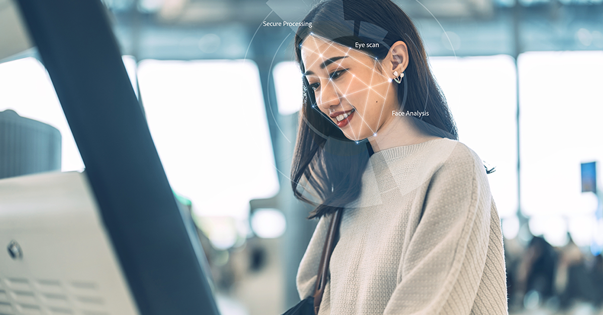 Passenger at international airport terminal for departure with airline transport. Tourist woman face detection biometric identity using self service check in kiosk machine.