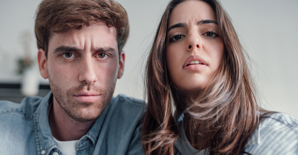 Confused couple touching camera
