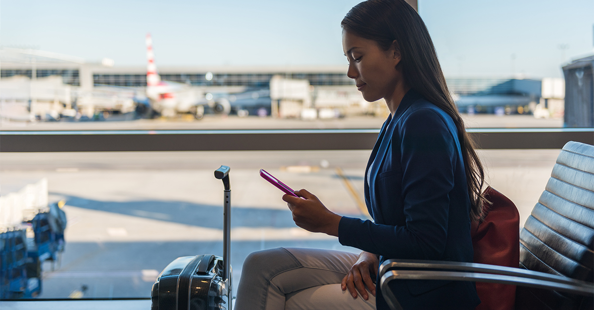 Downloaded Airport phone travel woman using mobile phone in business class lounge waiting for plane flight texting sms message on smartphone. Technology and travel people frequent flying lifestyle.